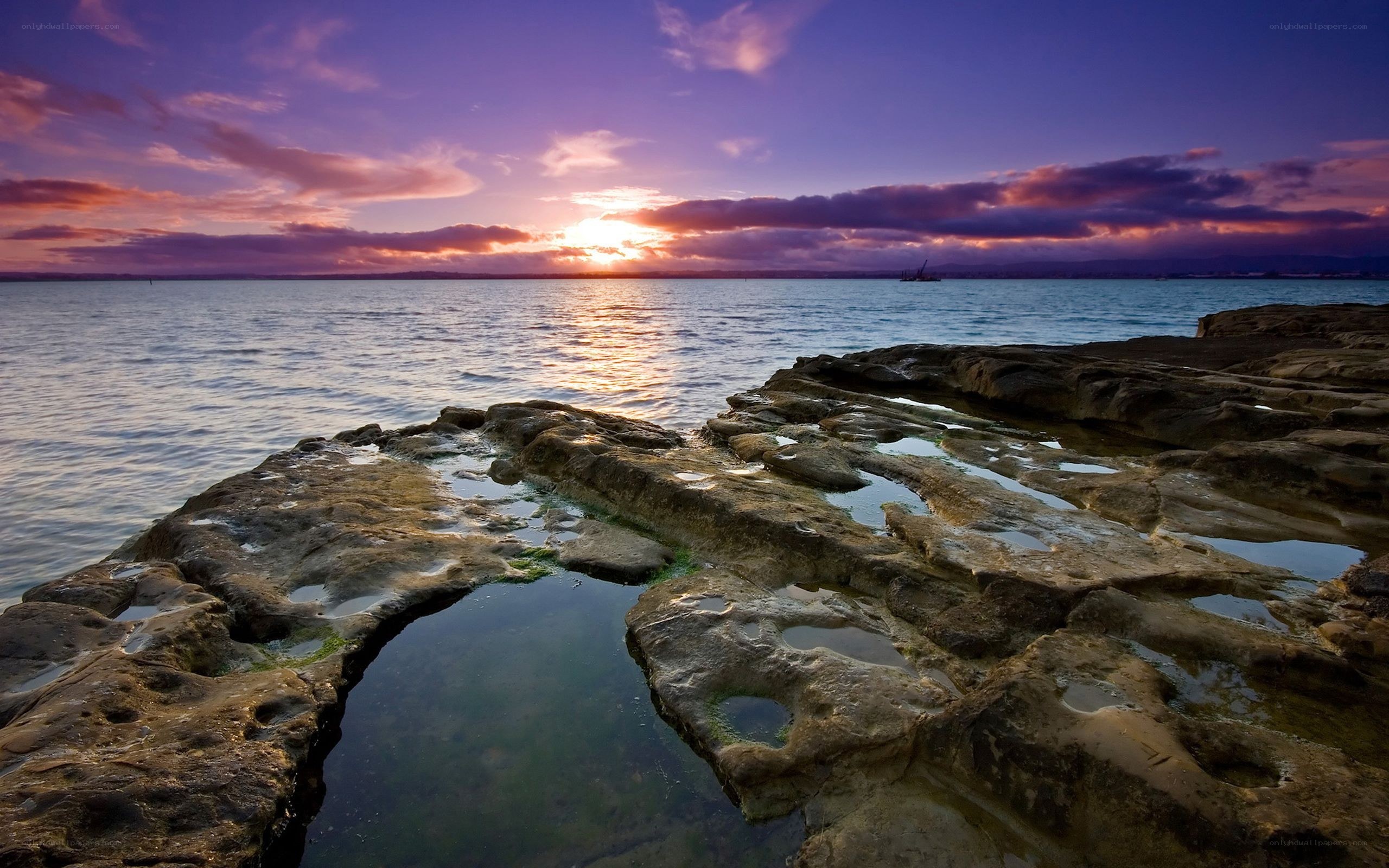 Sunset over rocky shoreline
