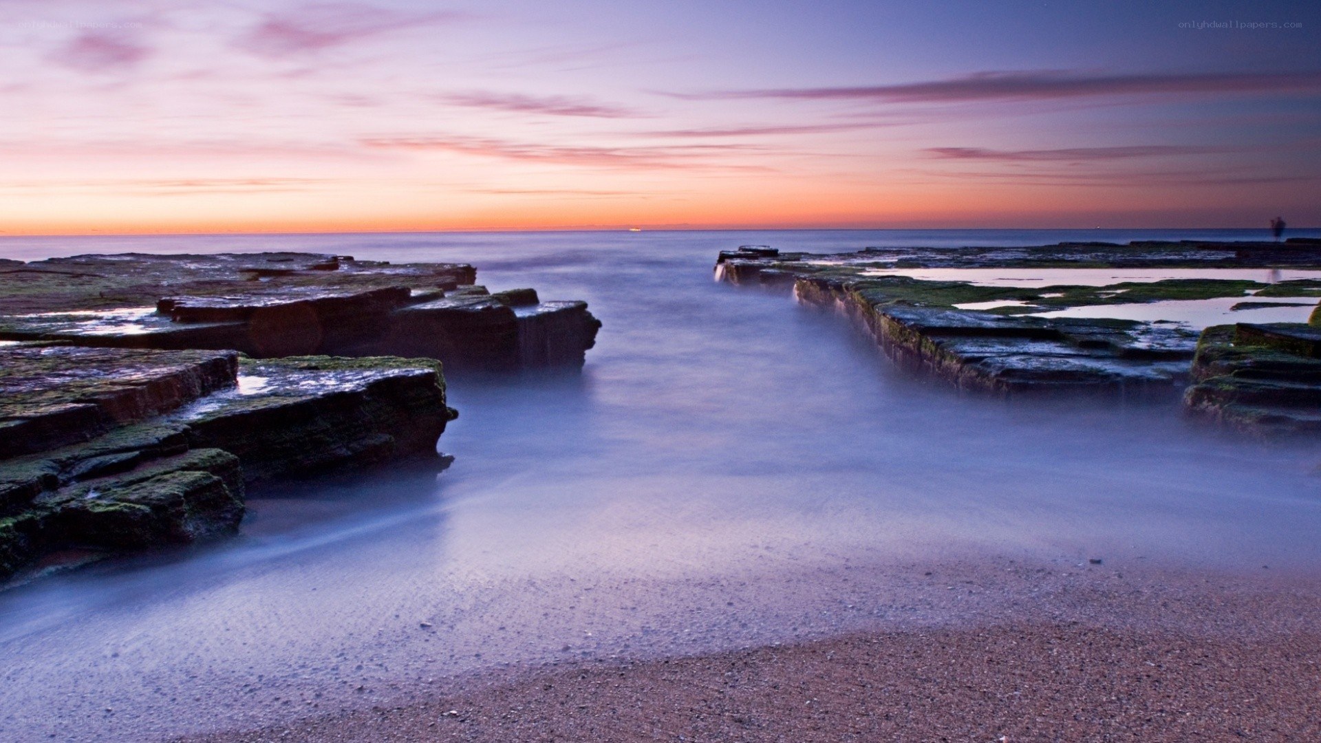 Sunset over rocky shoreline