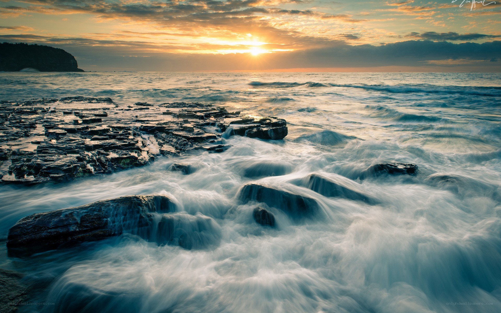 Sunset over rocky shoreline