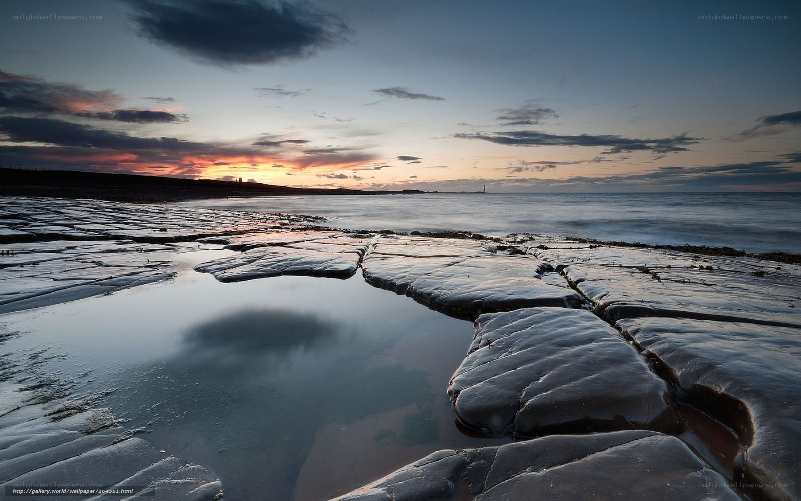 Sunset over rocky shoreline