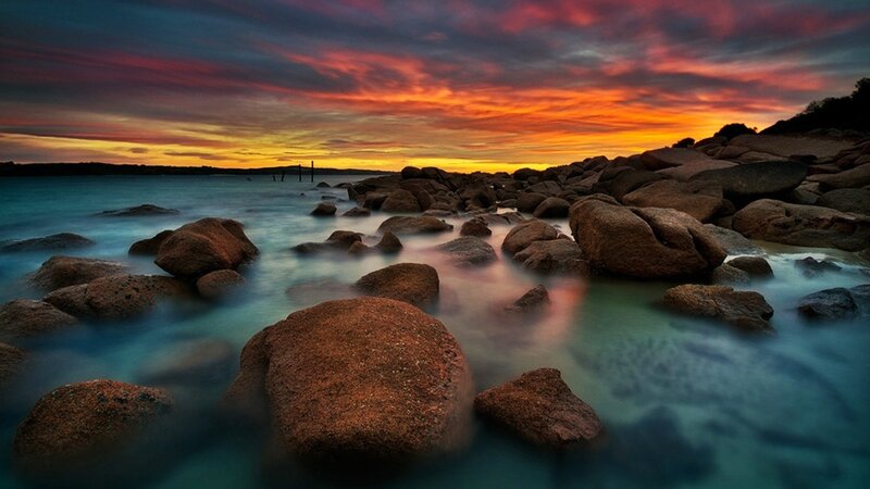 Sunset over rocky shoreline