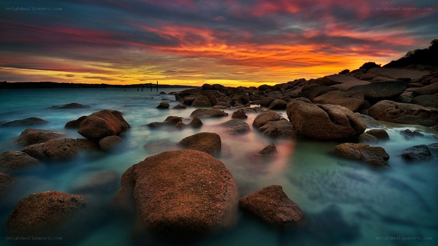 Sunset over rocky shoreline