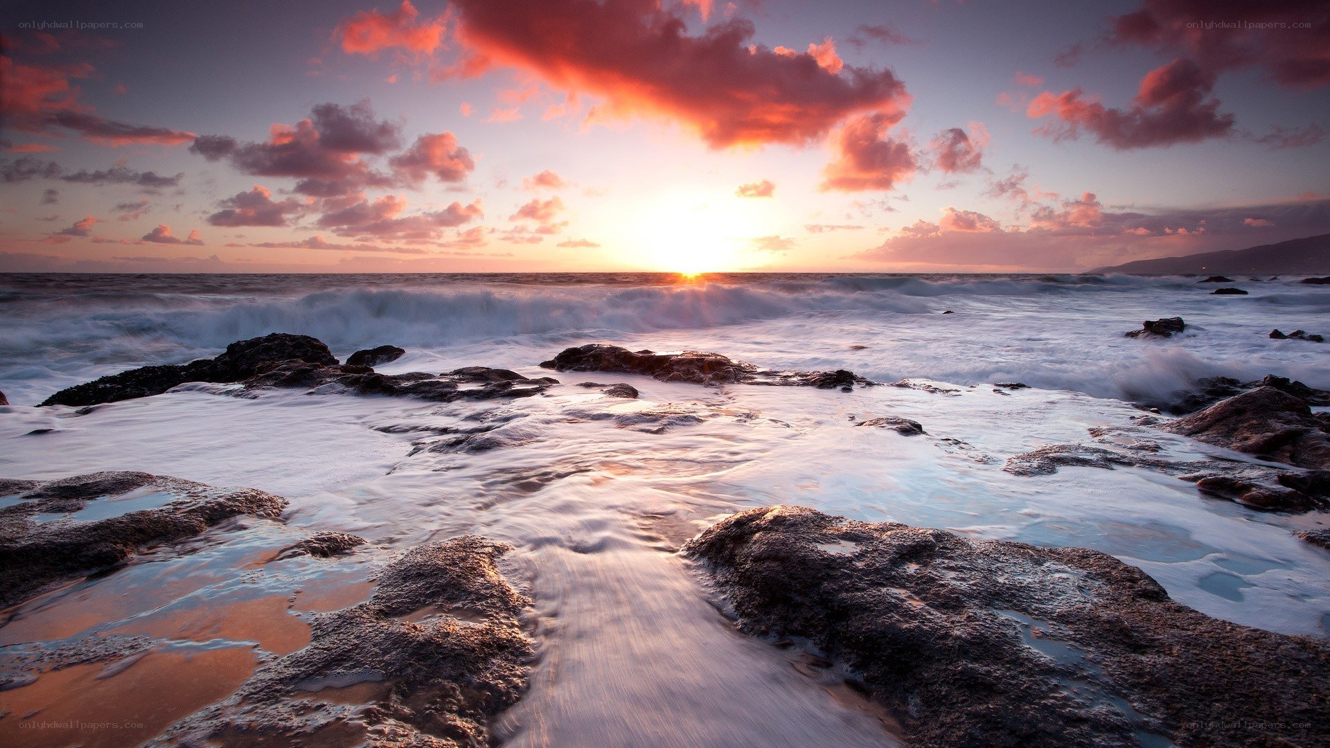 Sunset over rocky shoreline
