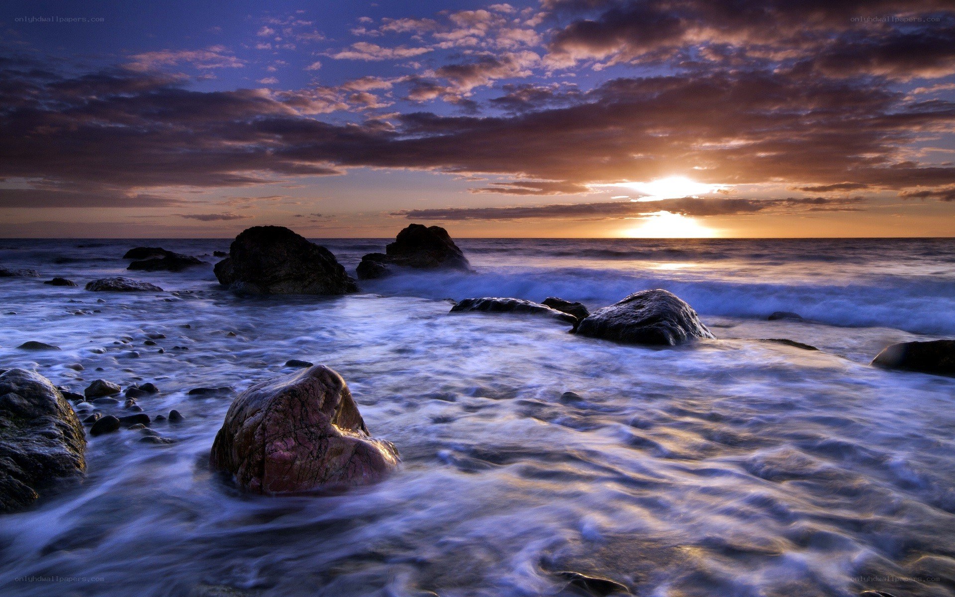 Sunset over rocky shoreline
