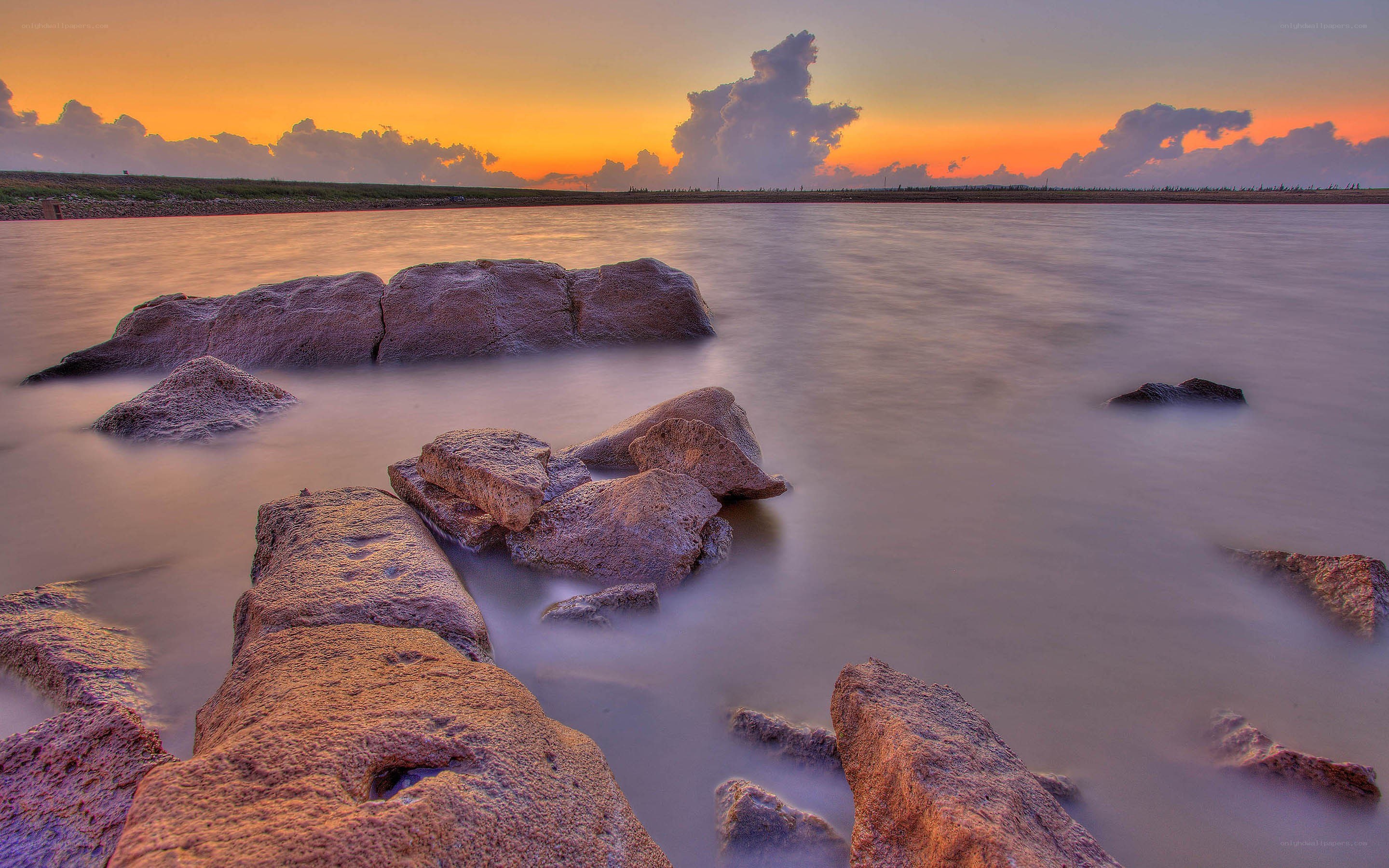 Sunset over rocky shoreline