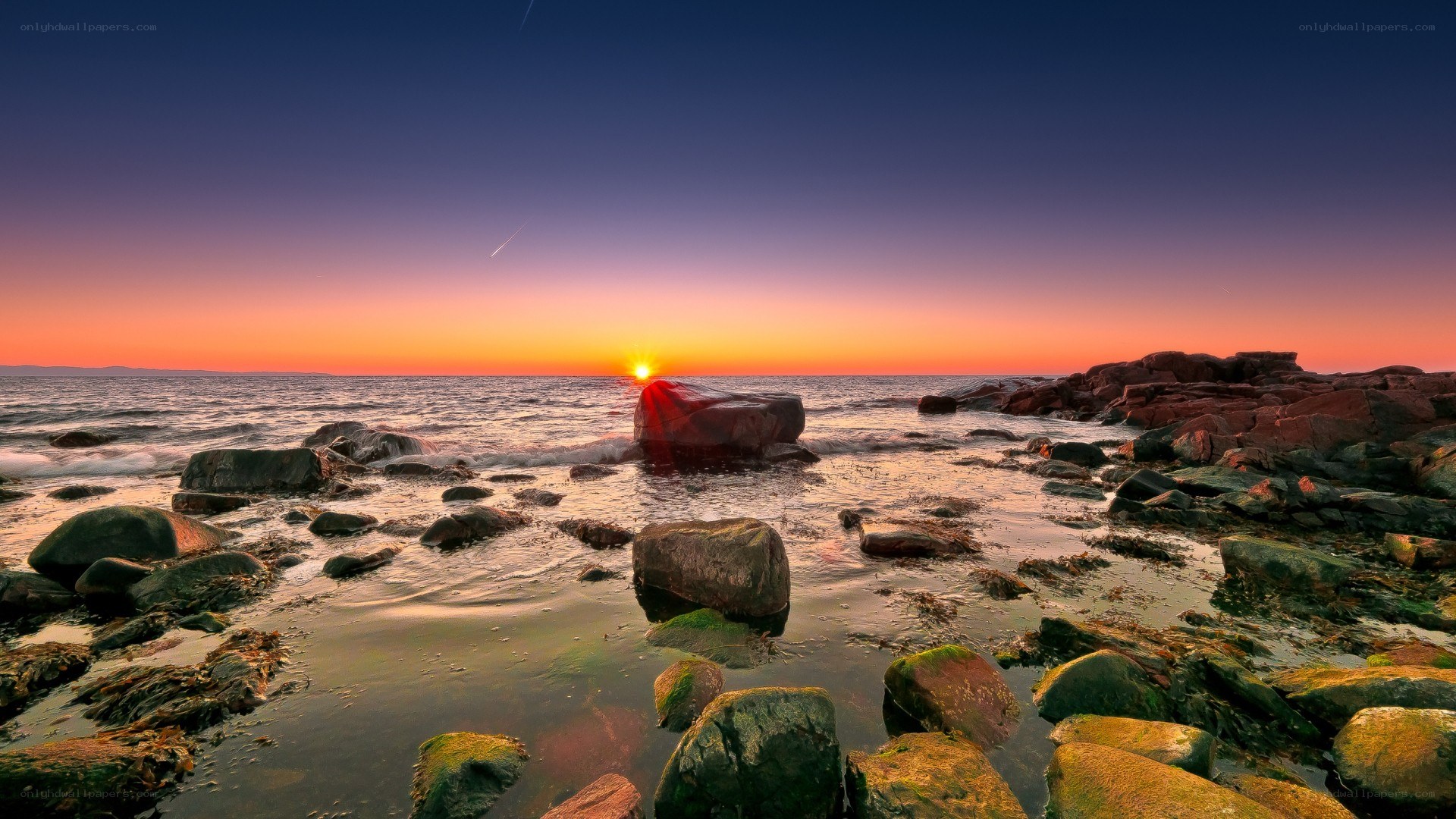 Sunset over rocky shoreline