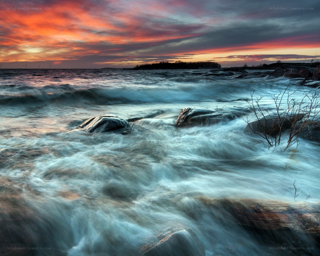 Sunset over rocky shoreline