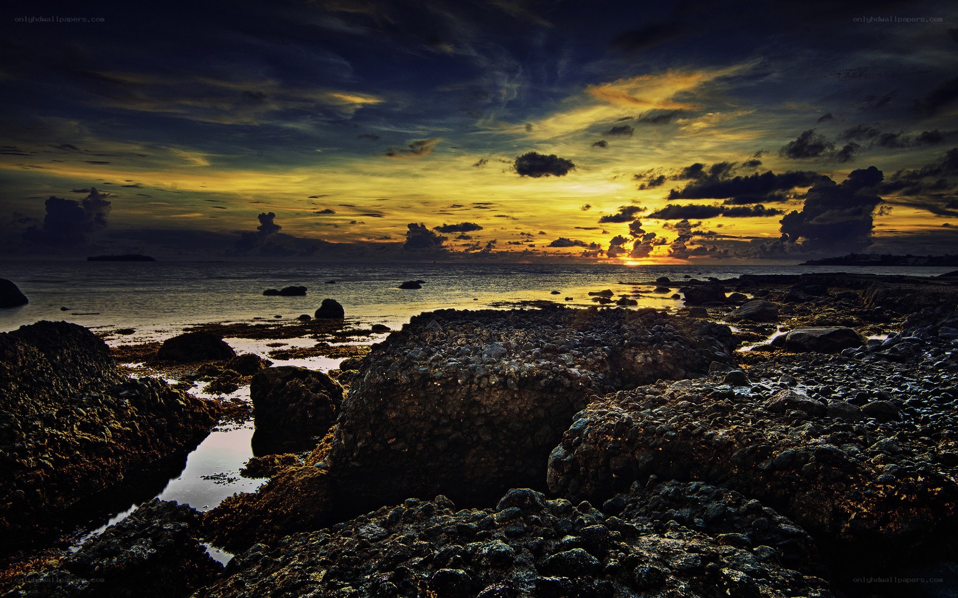 Sunset over rocky shoreline