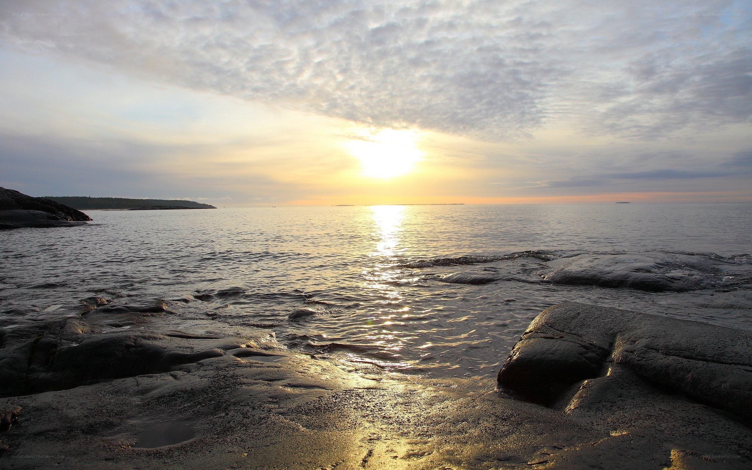 Sunset over rocky shoreline