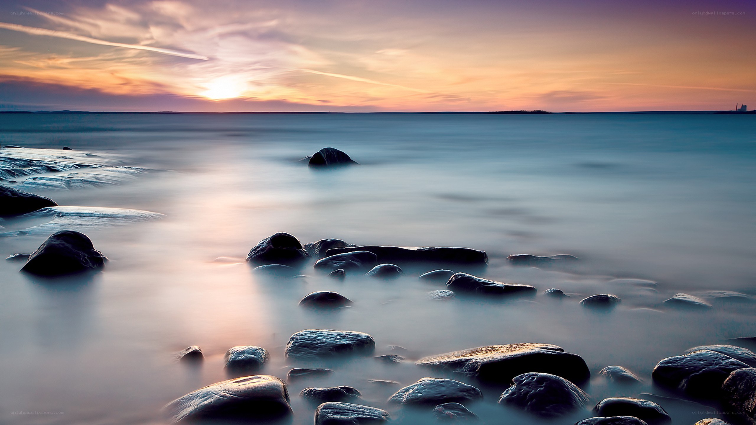 Sunset over rocky shoreline
