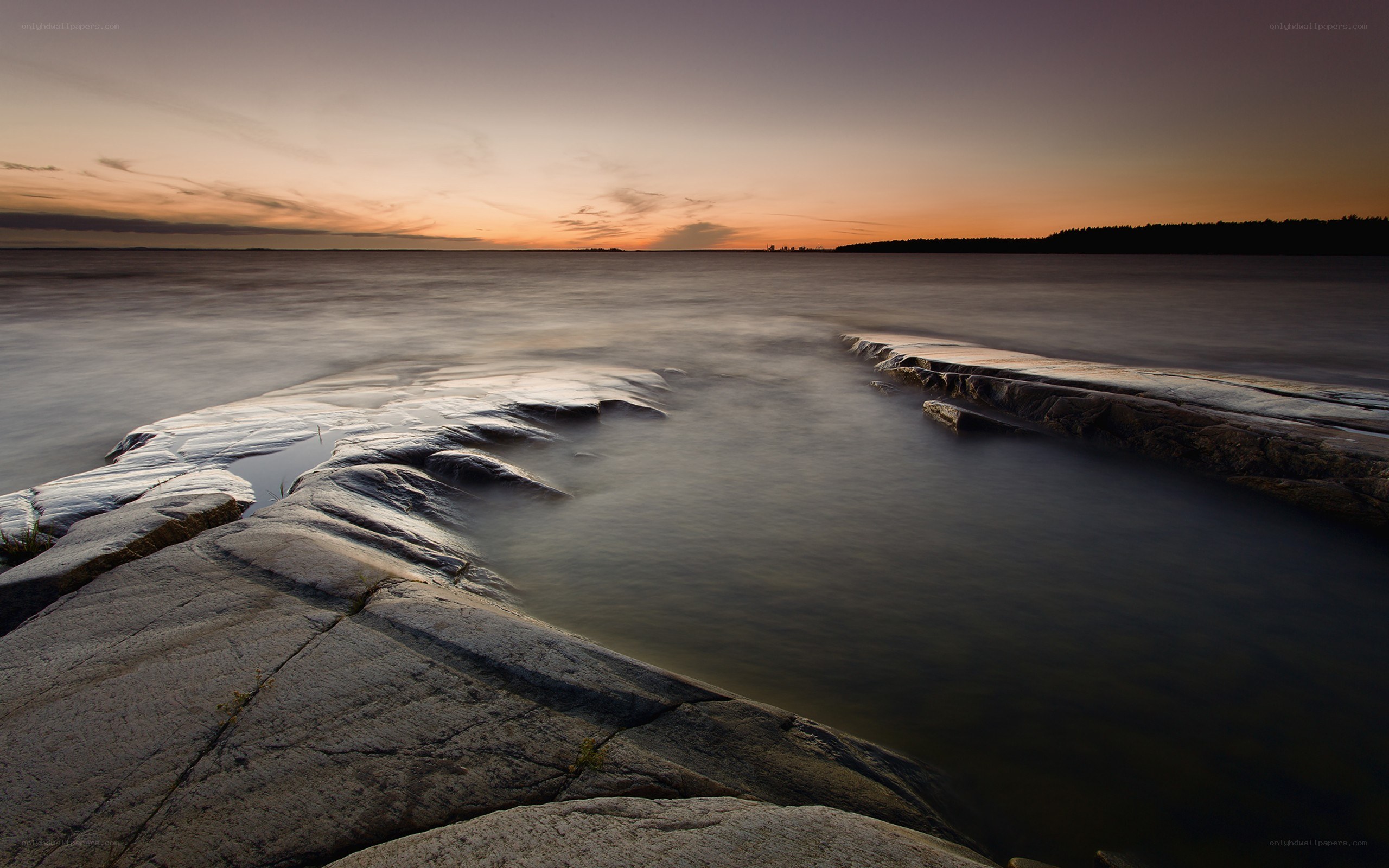Sunset over rocky shoreline