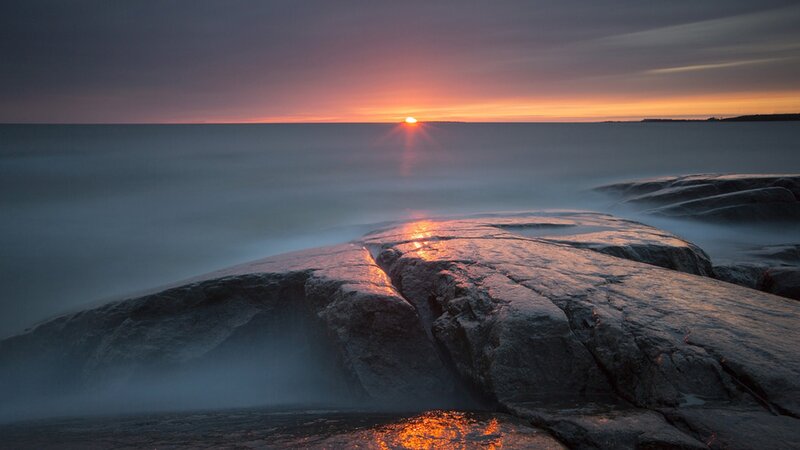 Sunset over rocky shoreline