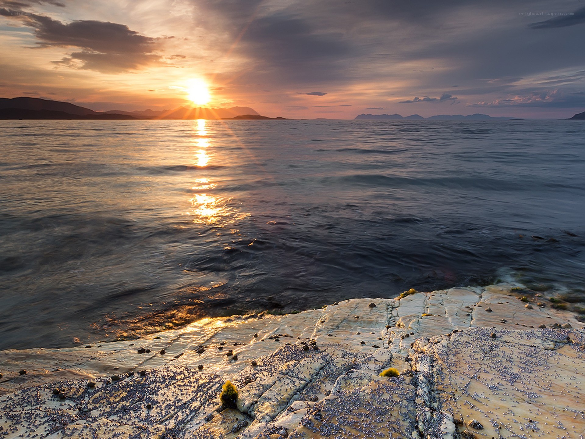 Sunset over rocky shoreline
