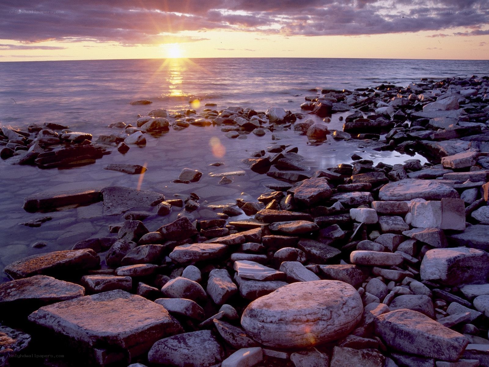 Sunset over rocky shoreline