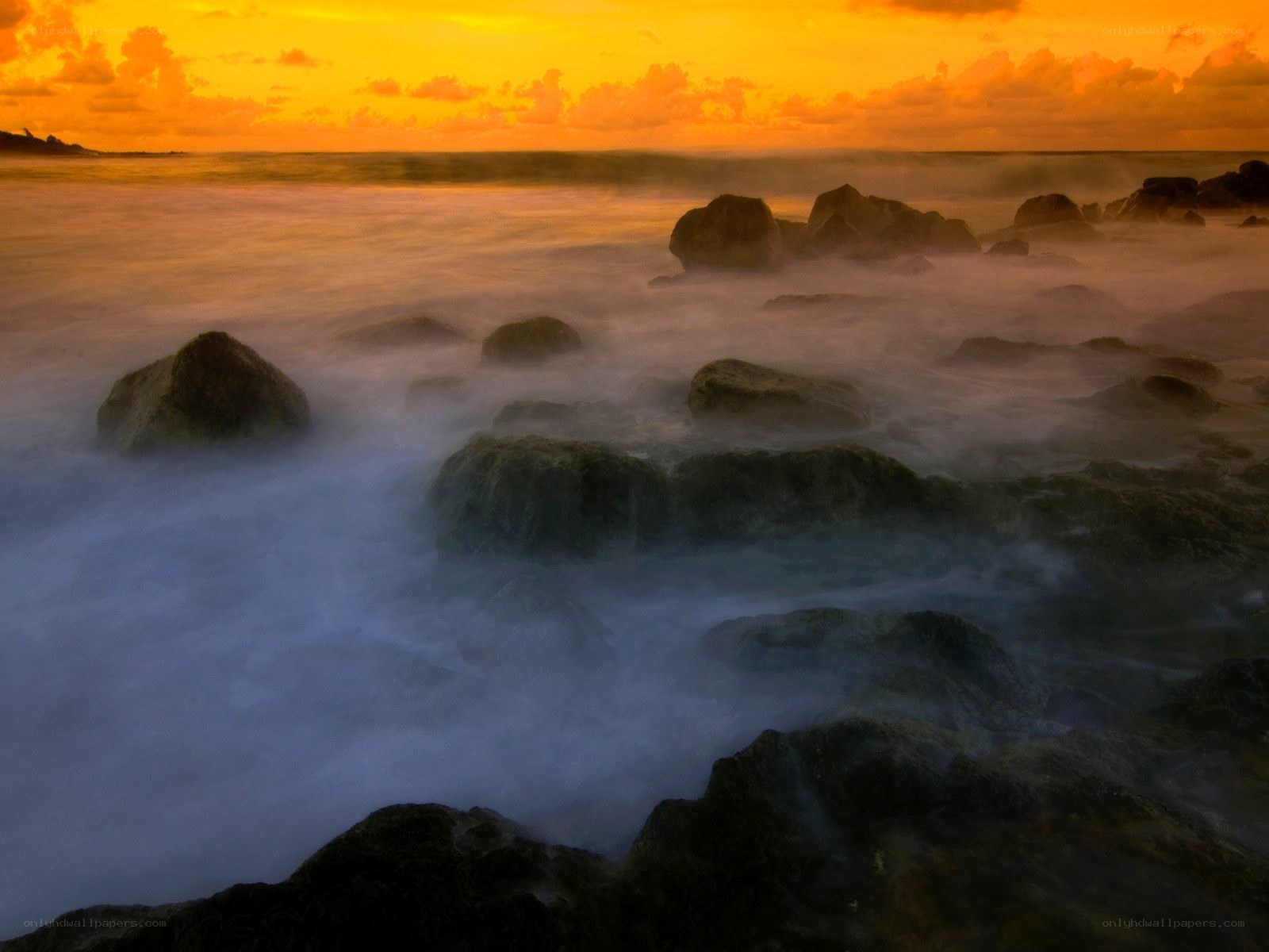 Sunset over rocky shoreline