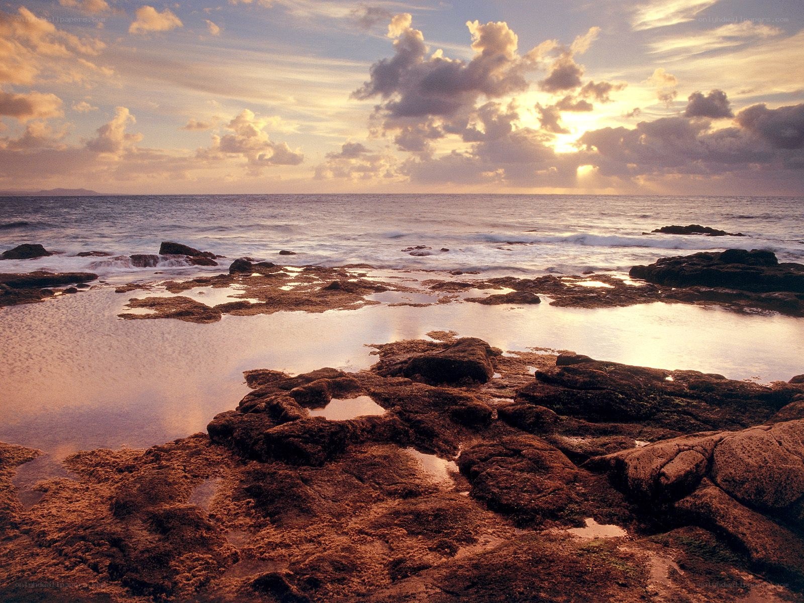 Sunset over rocky shoreline