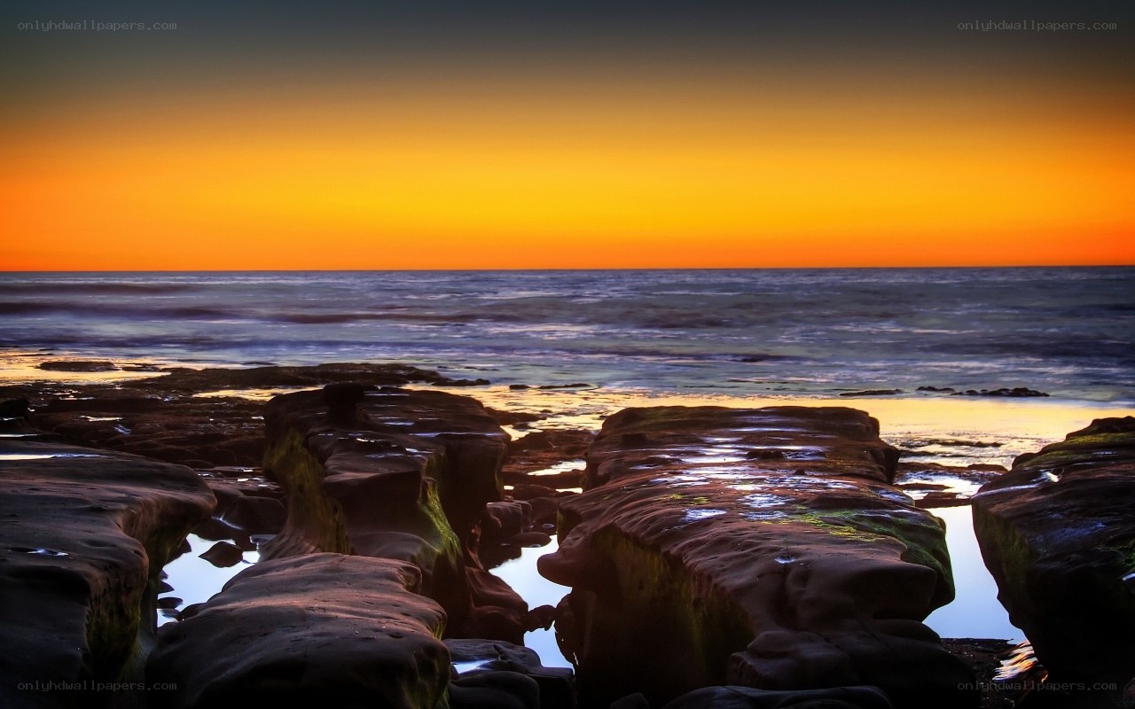 Sunset over rocky shoreline