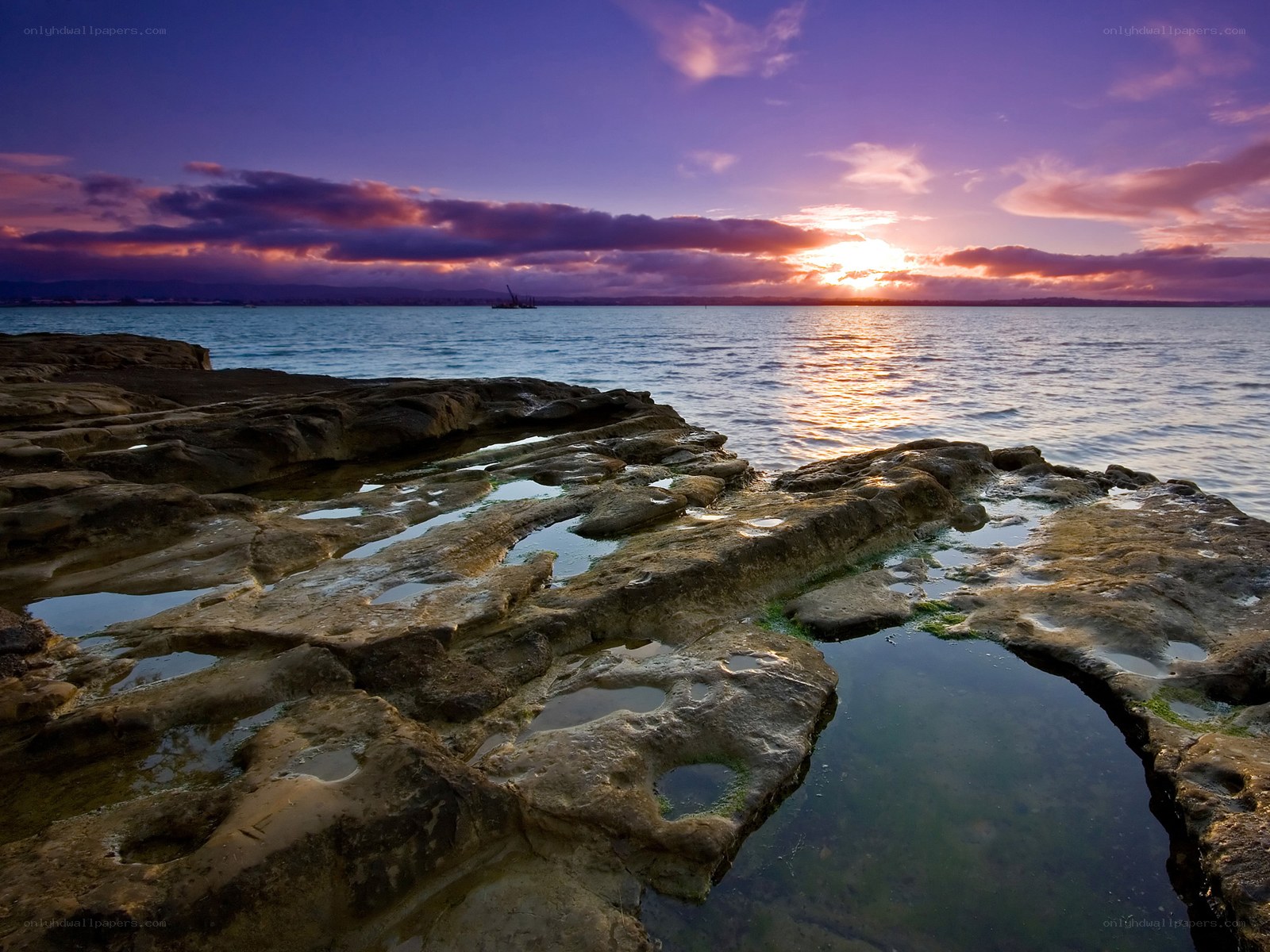 Sunset over rocky shoreline
