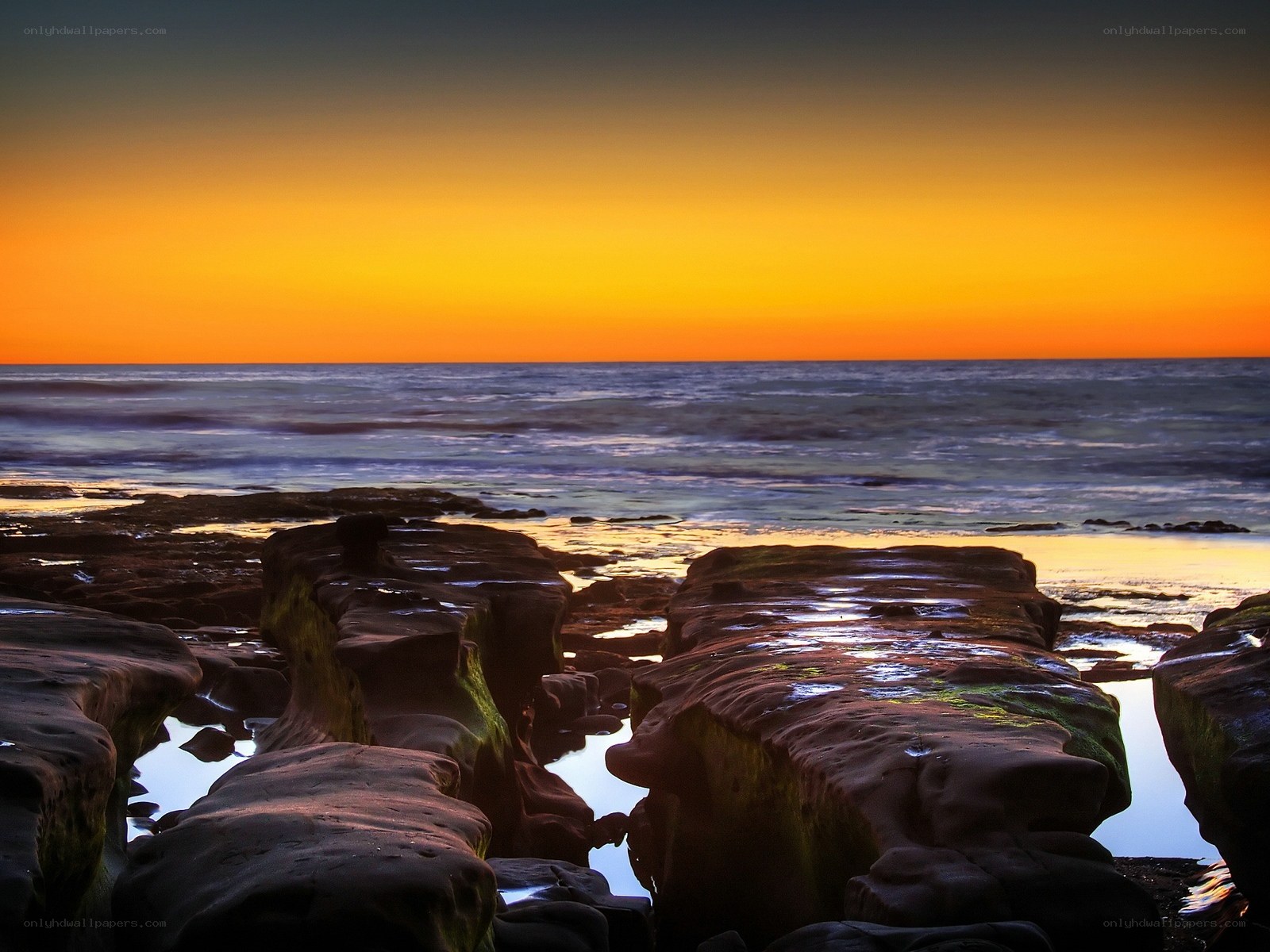 Sunset over rocky shoreline