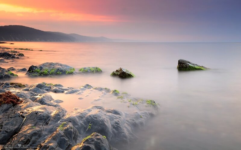 Sunset over rocky shoreline