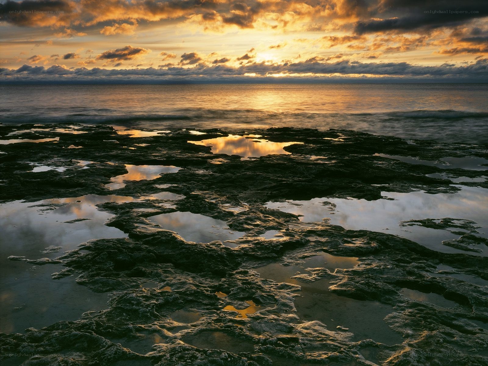 Sunset over rocky shoreline