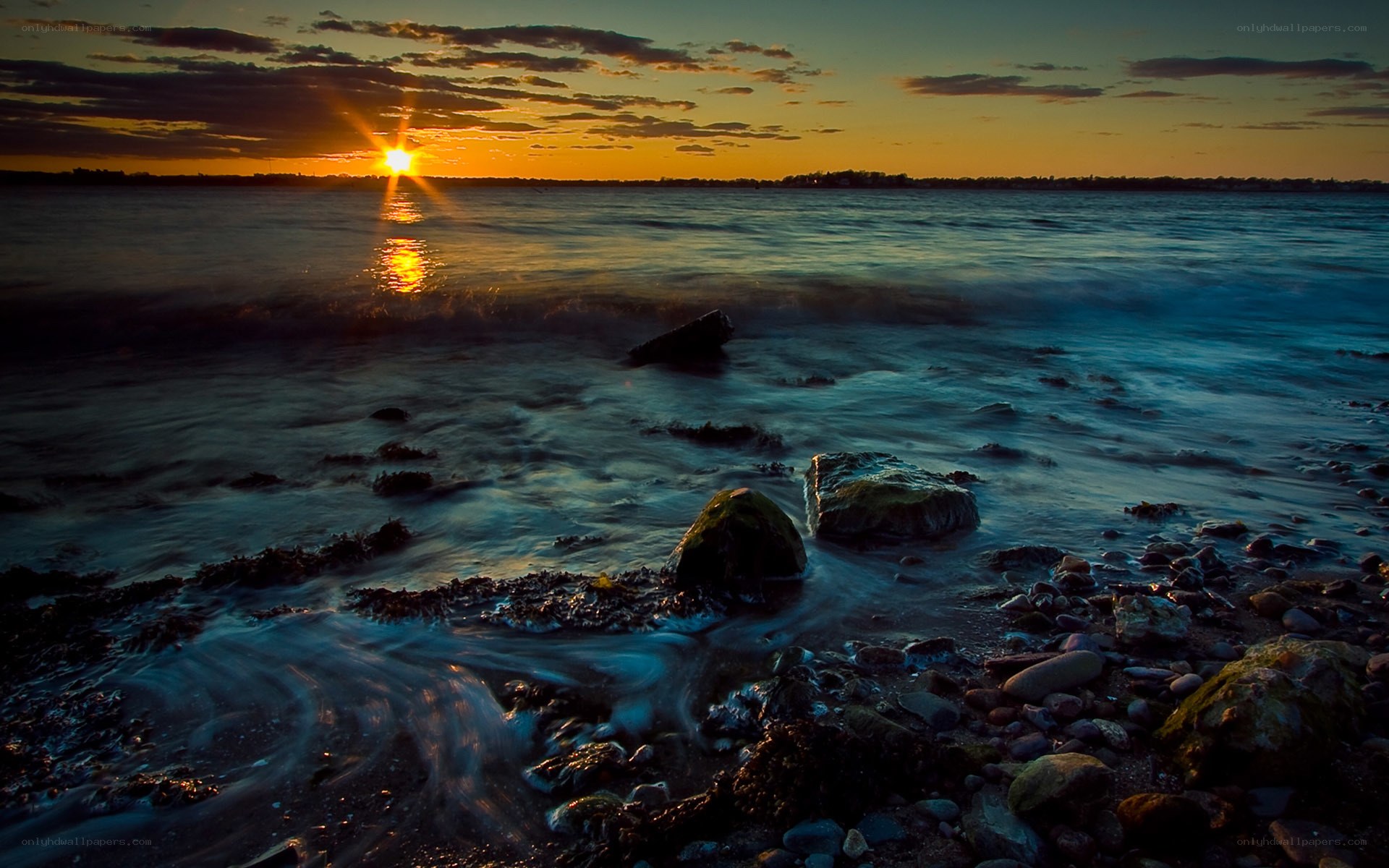 Sunset over rocky shoreline