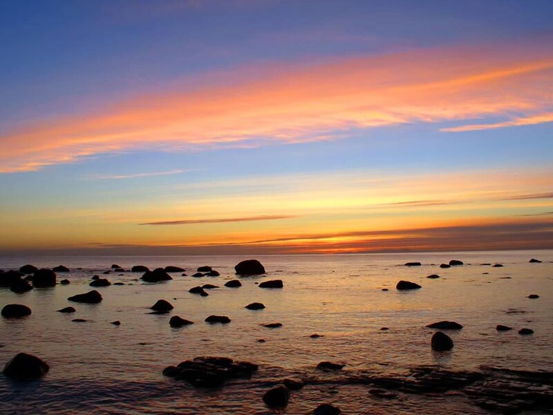 sunset over rocky shoreline