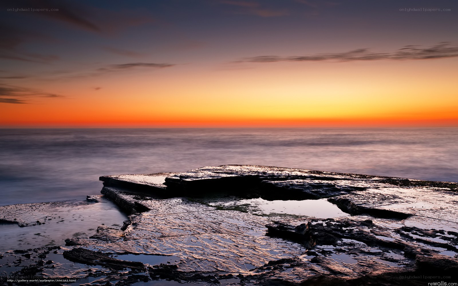 Sunset over rocky shoreline