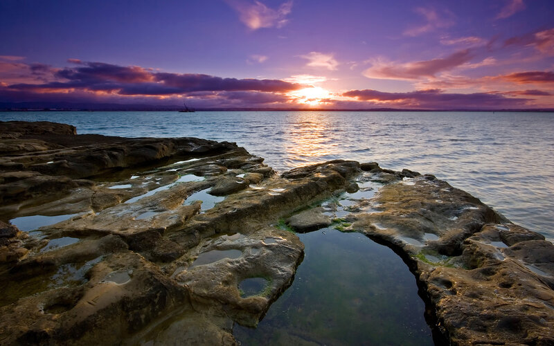 Sunset over rocky shoreline