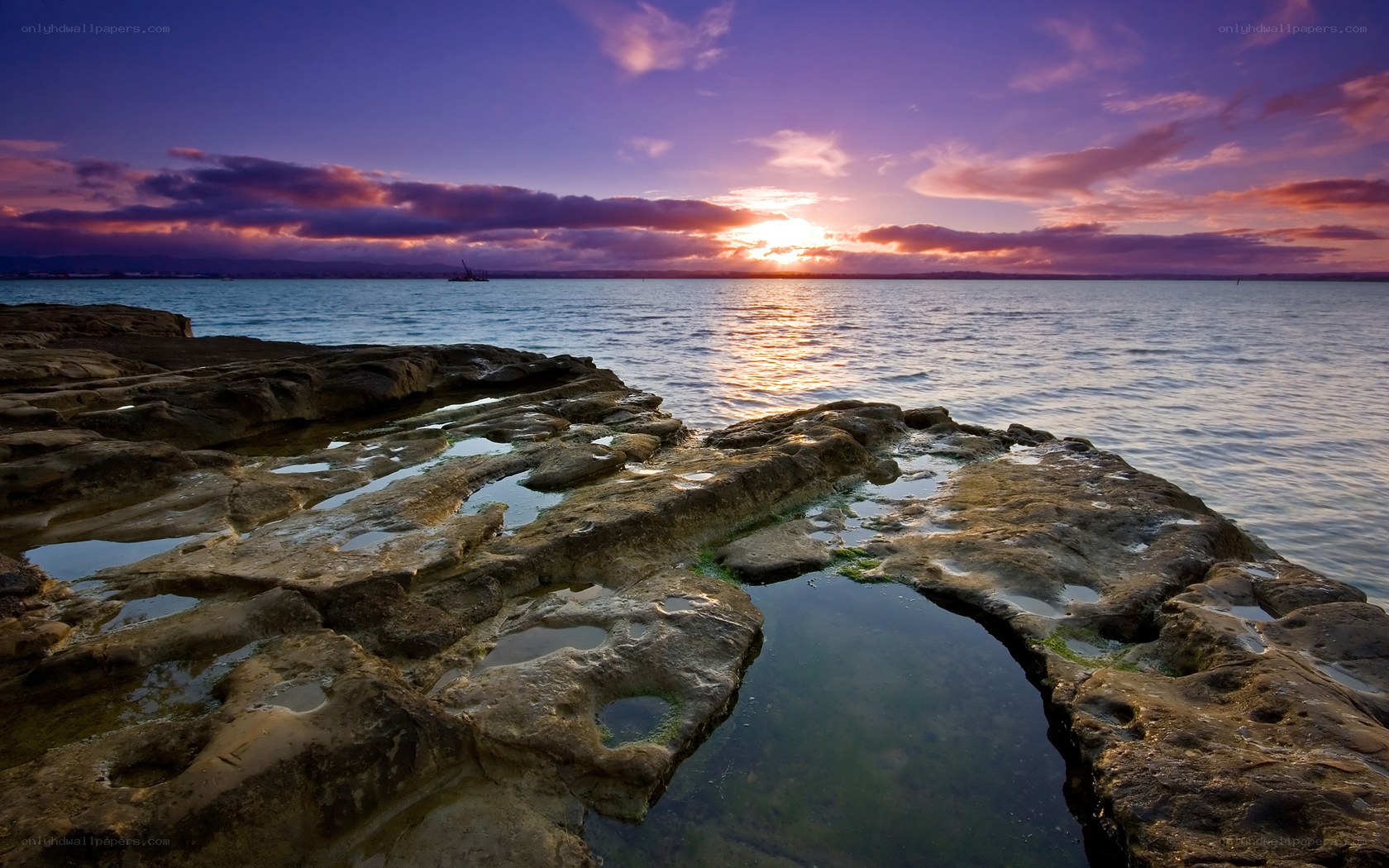 Sunset over rocky shoreline