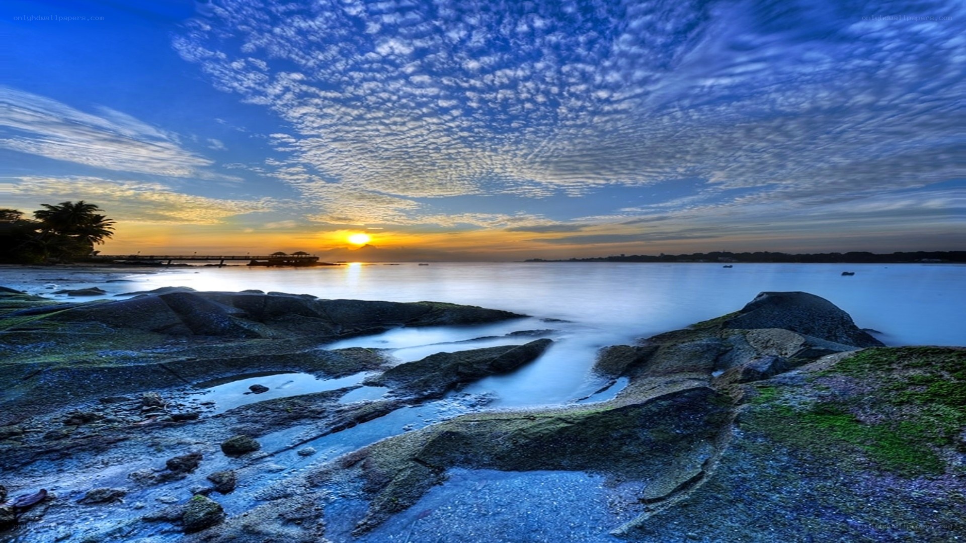 Sunset over rocky shoreline