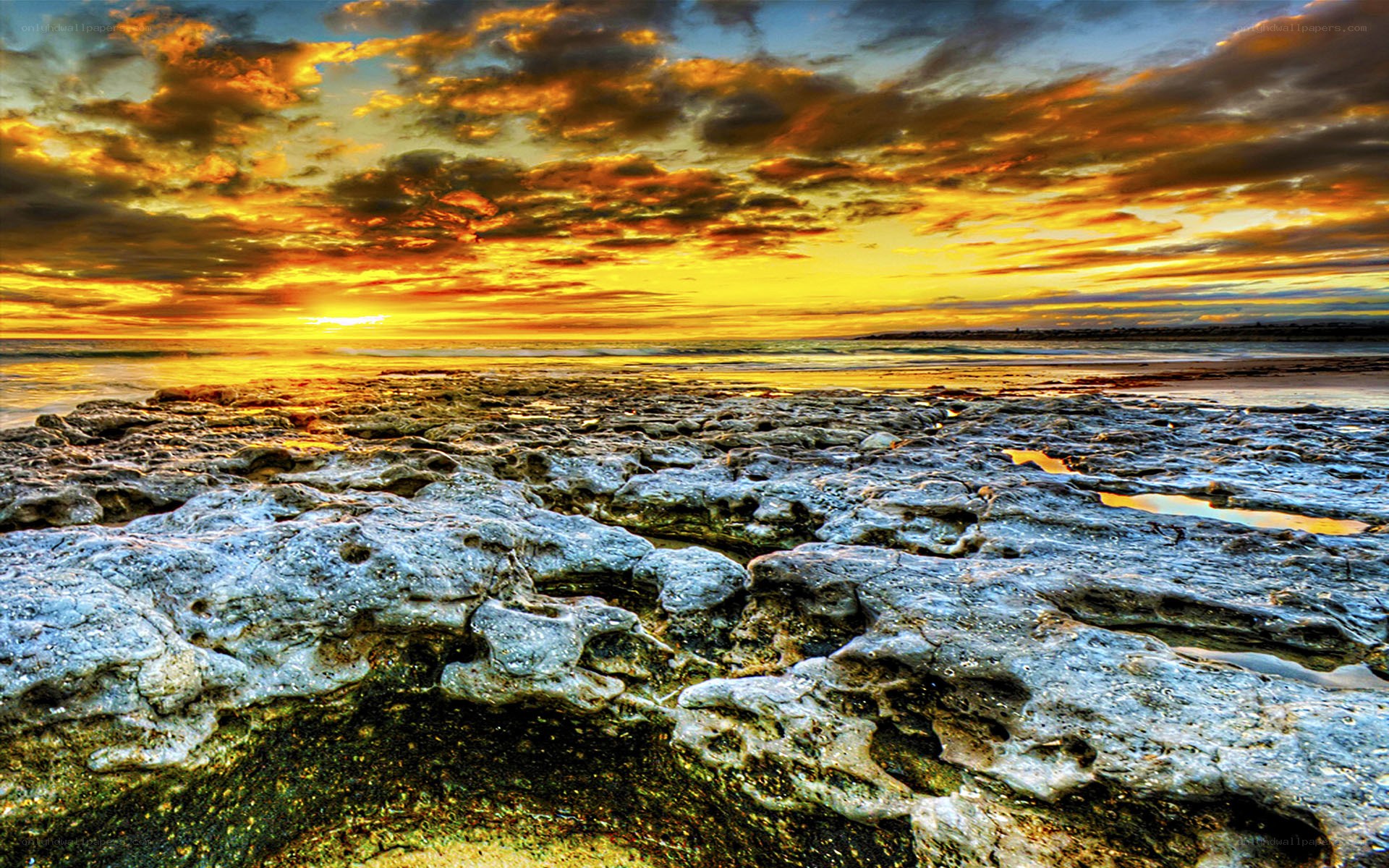 Sunset over rocky shoreline
