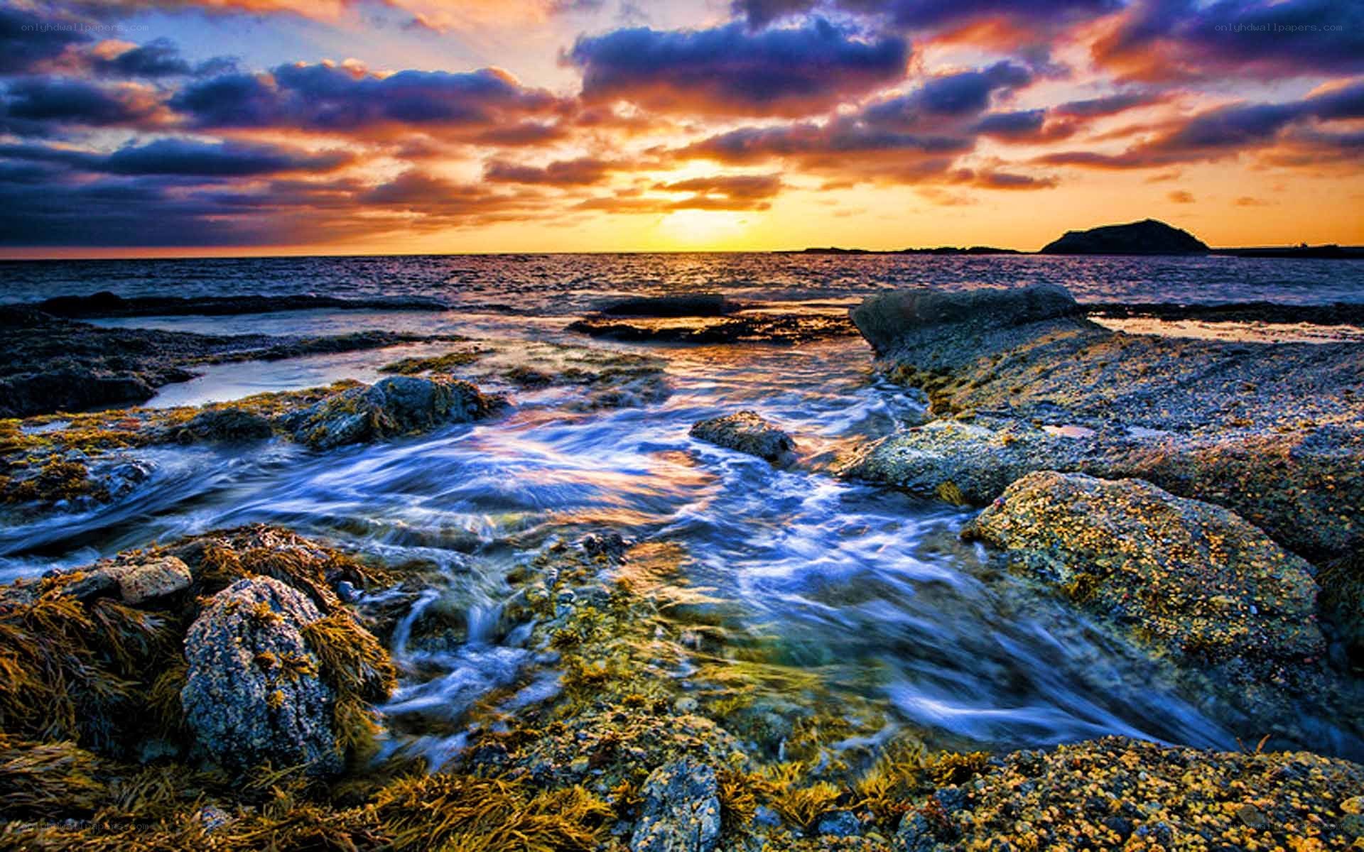 Sunset over rocky shoreline