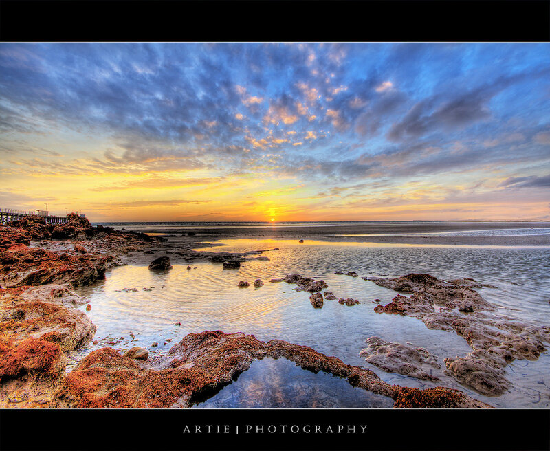 Sunset over rocky shoreline