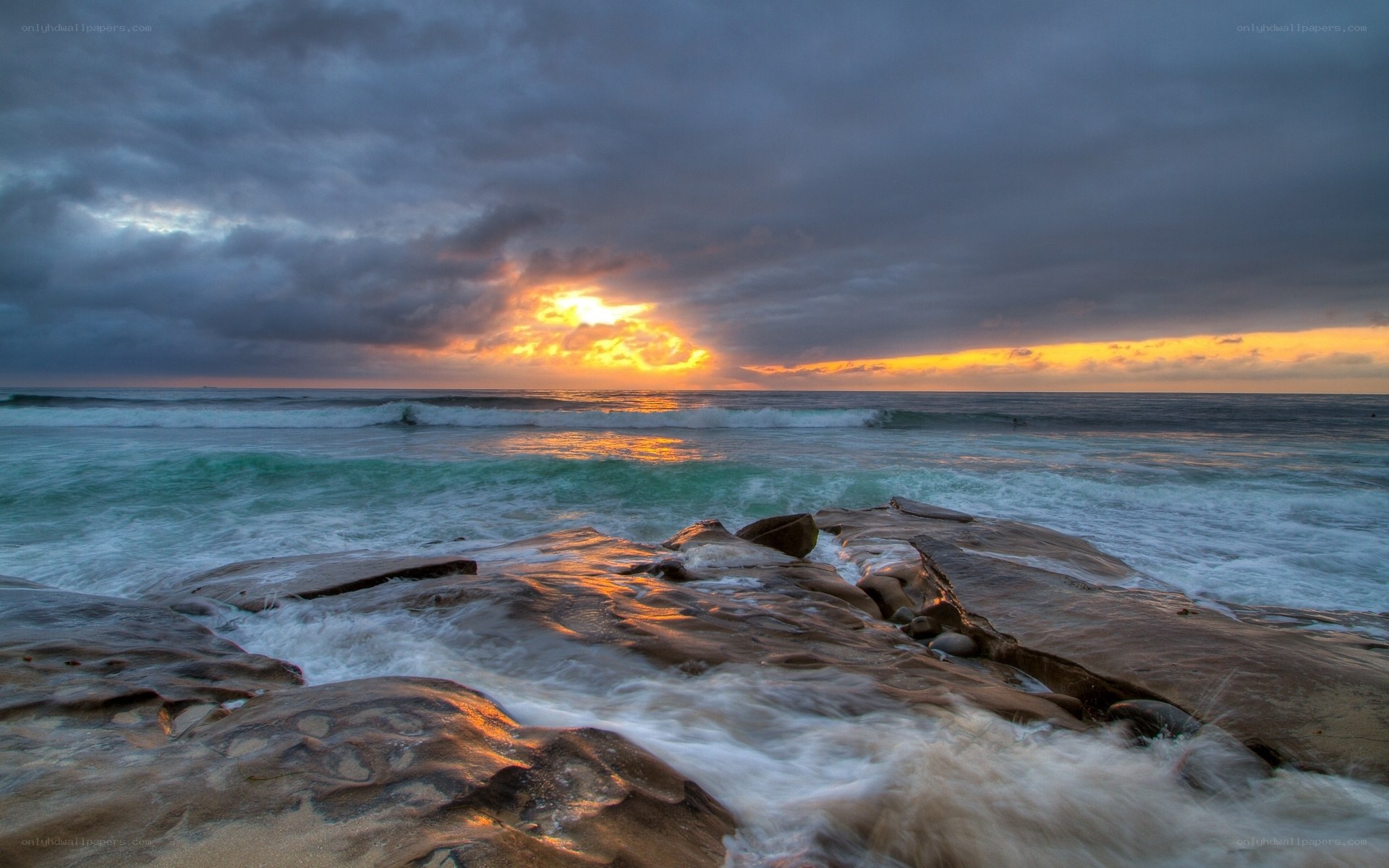 Sunset over rocky shoreline