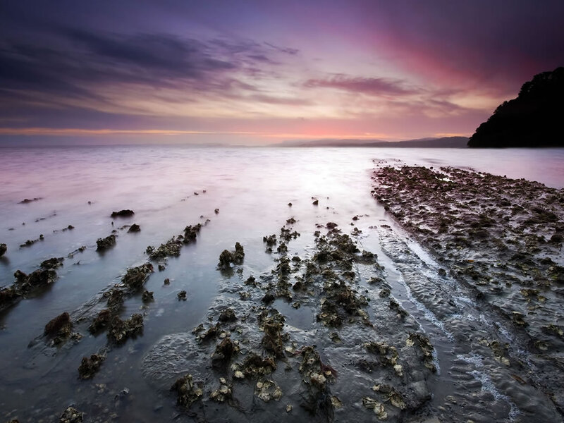 Sunset over rocky shoreline
