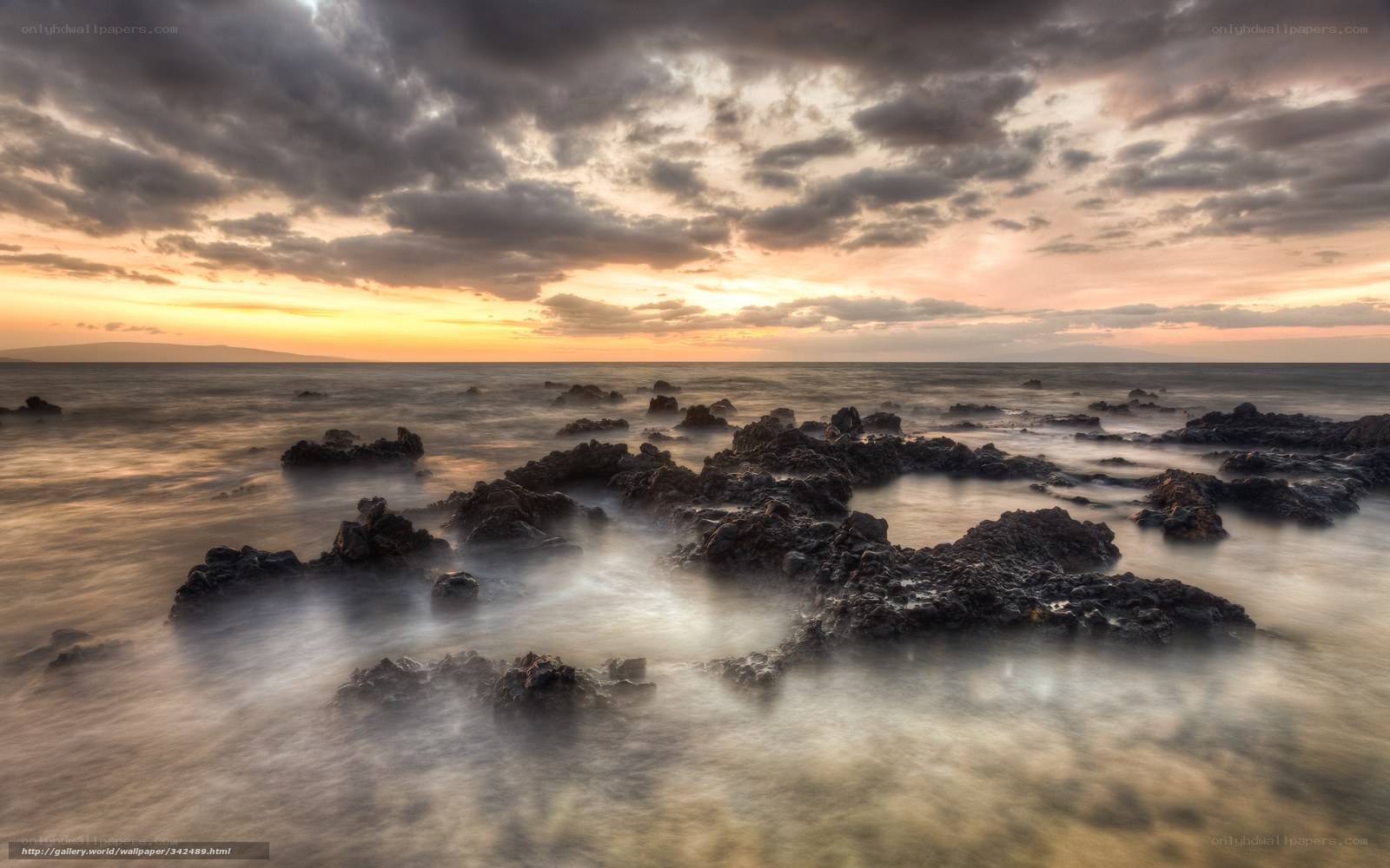 Sunset over rocky shoreline