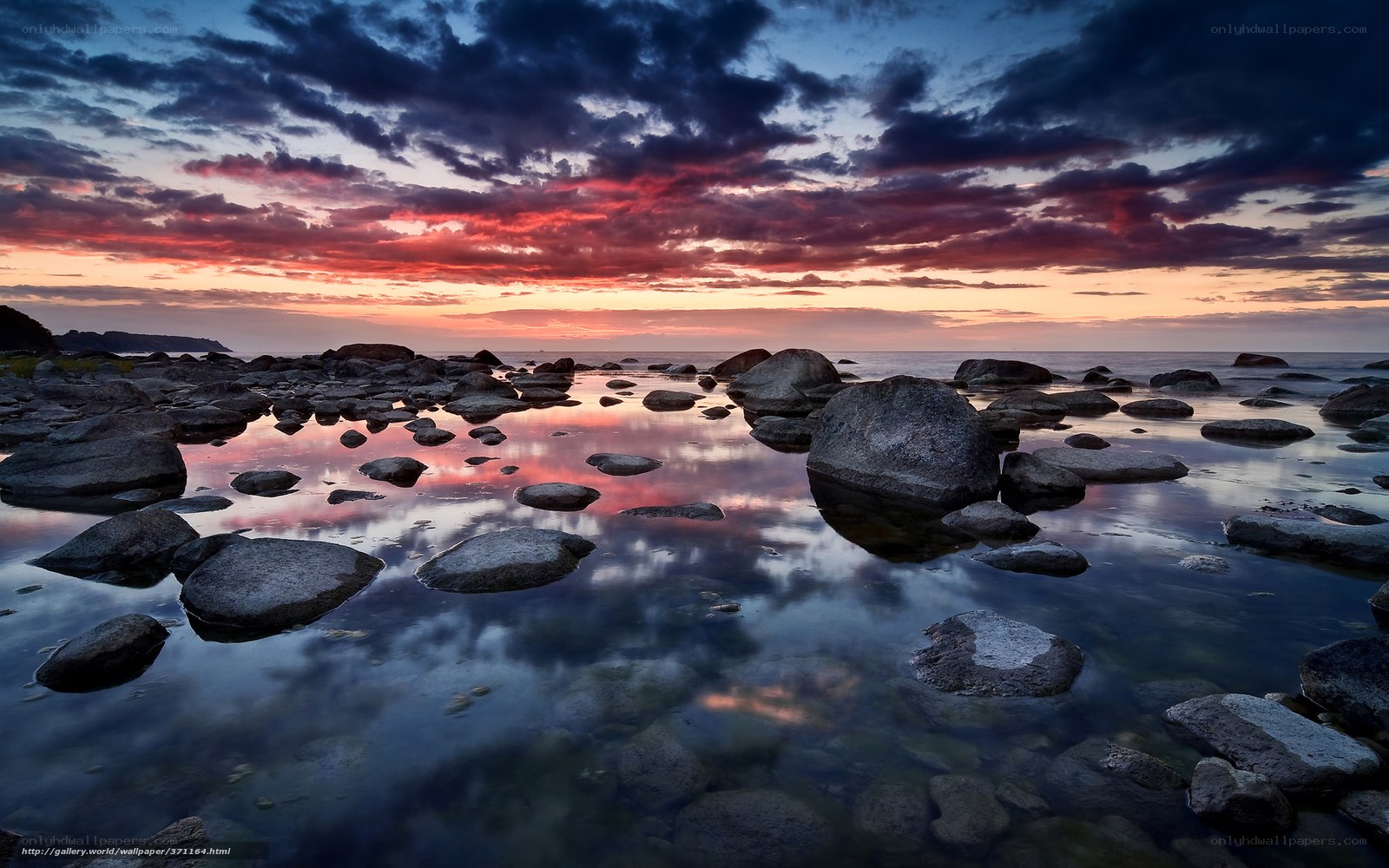 Sunset over rocky shoreline