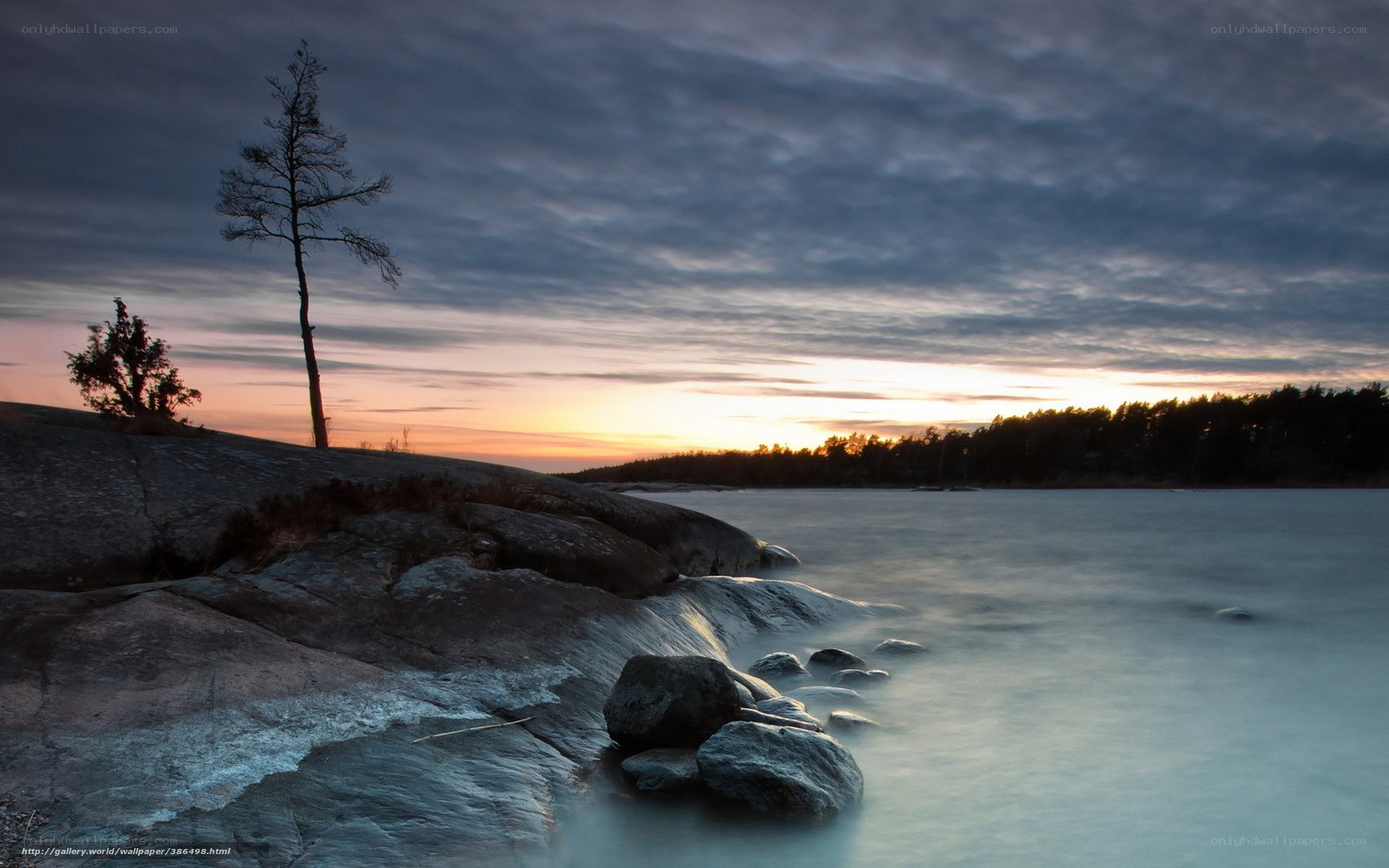 Sunset over rocky shoreline
