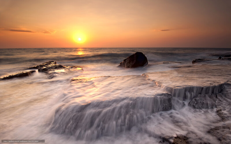Sunset over rocky shoreline