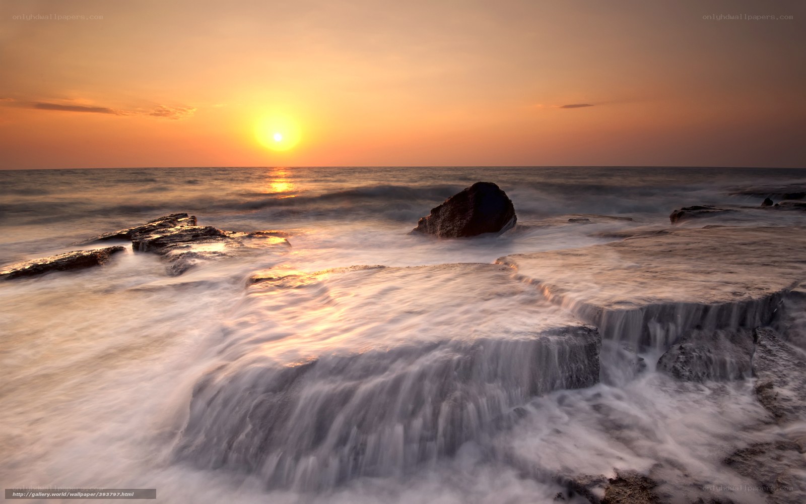 Sunset over rocky shoreline