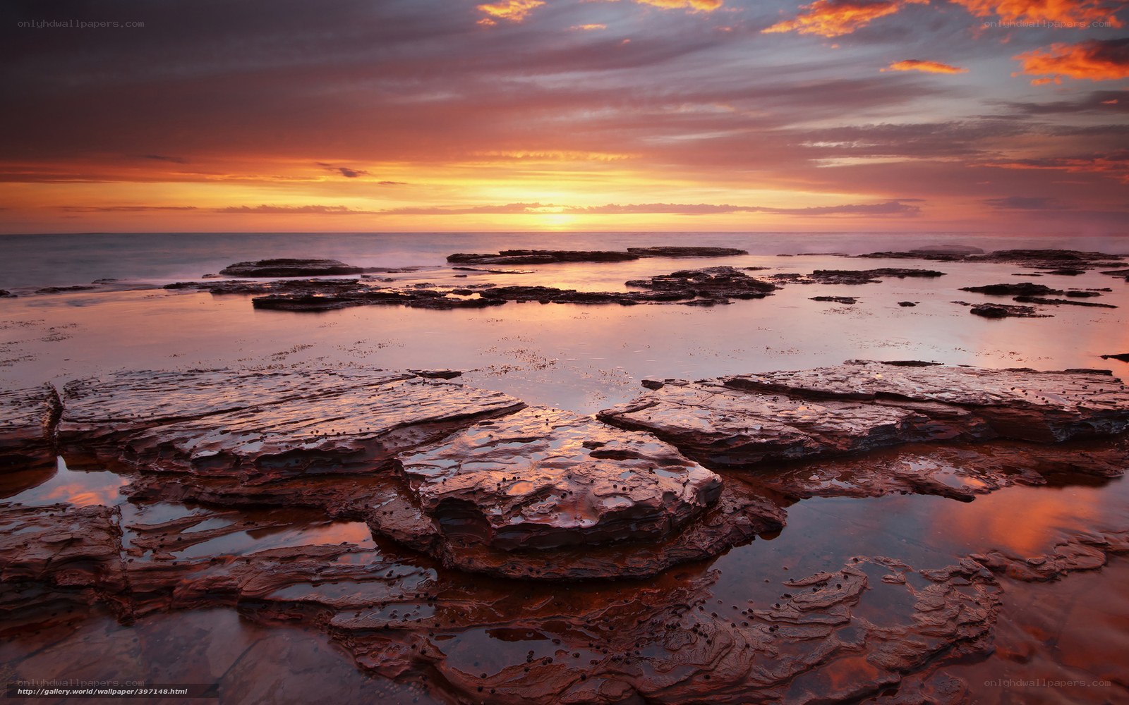 Sunset over rocky shoreline