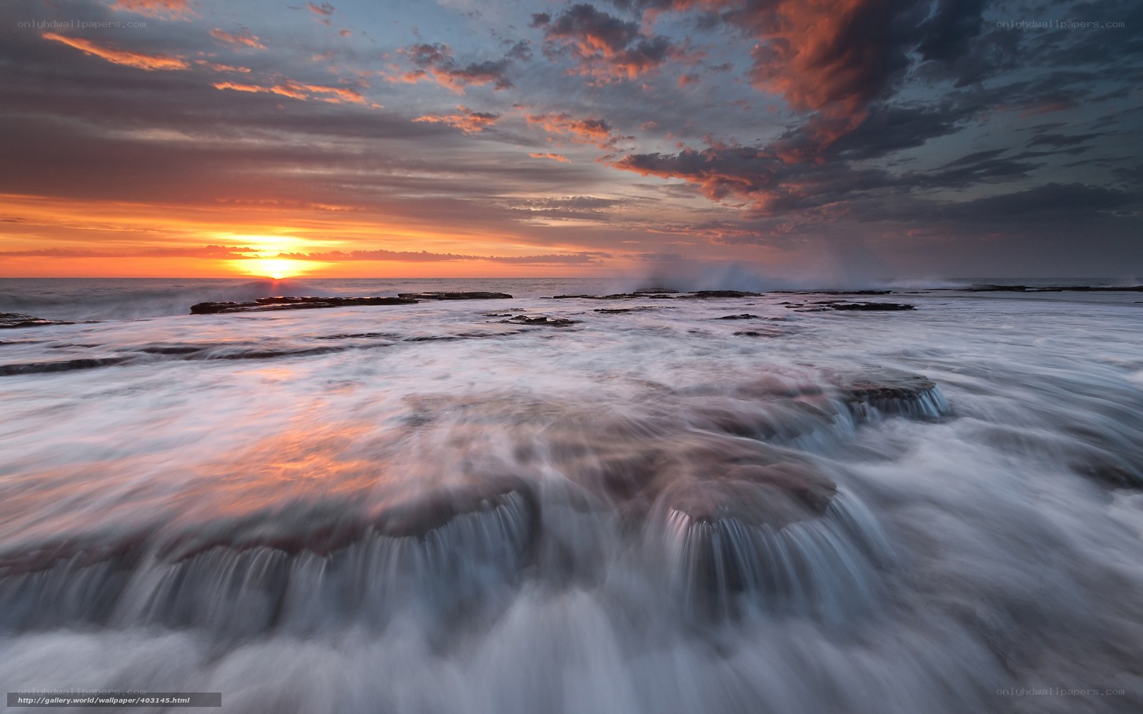 Sunset over rocky shoreline