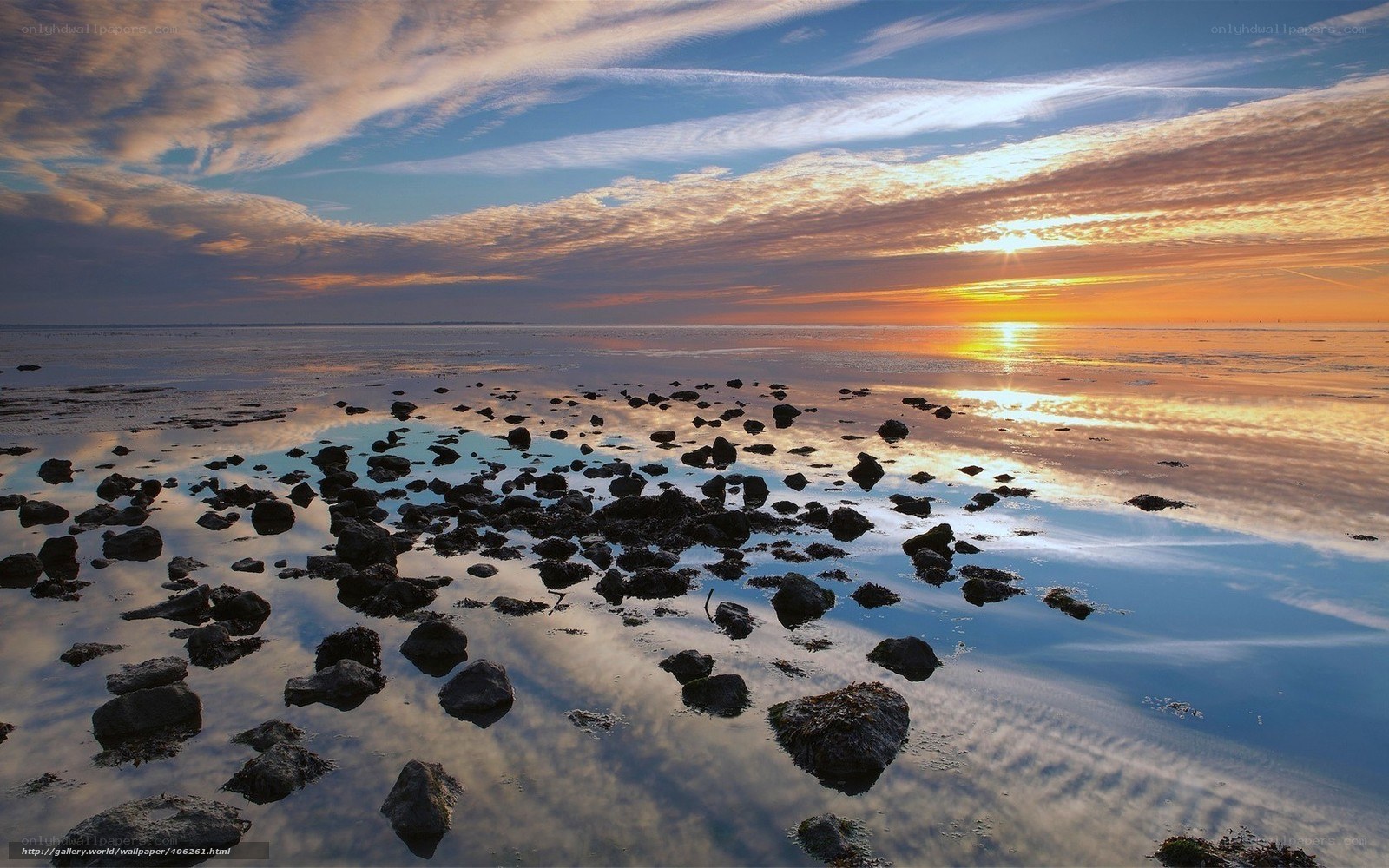 Sunset over rocky shoreline