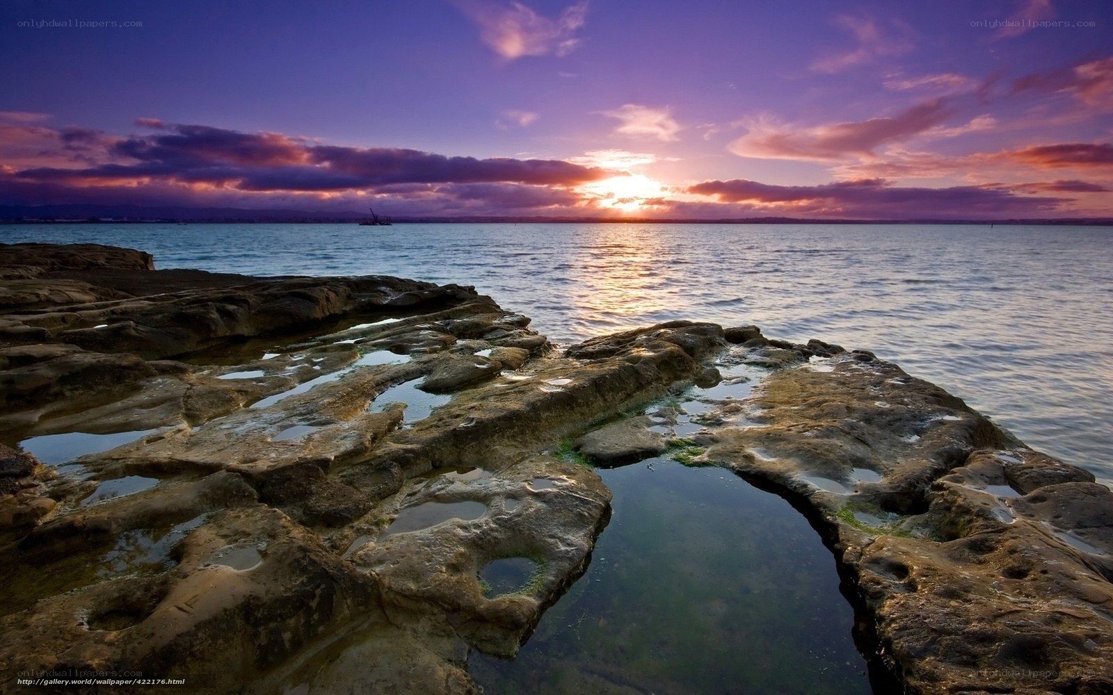 Sunset over rocky shoreline