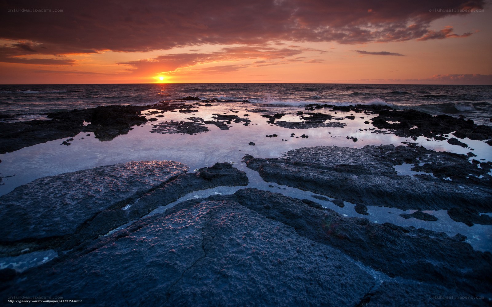 Sunset over rocky shoreline