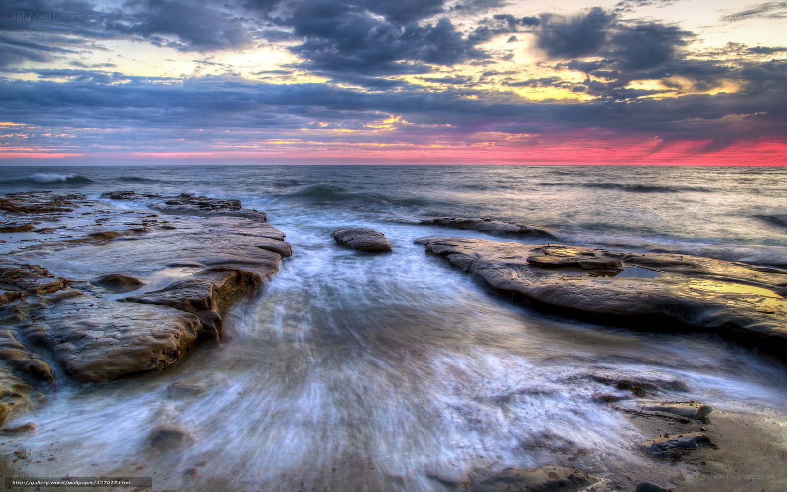 Sunset over rocky shoreline