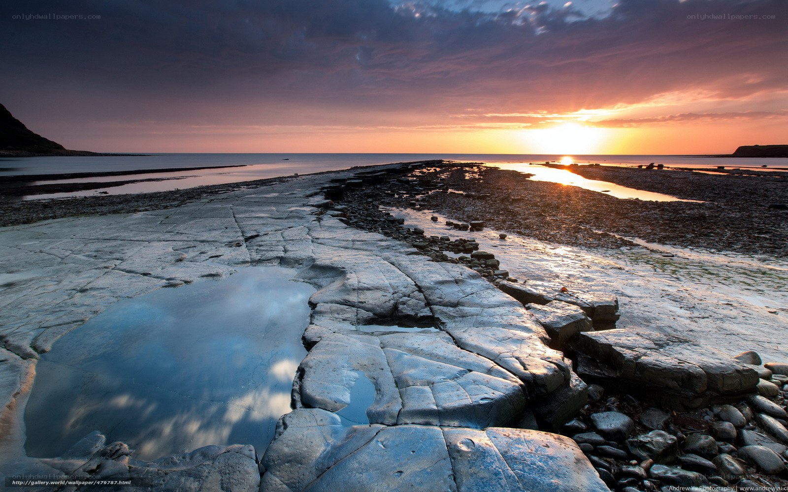 Sunset over rocky shoreline