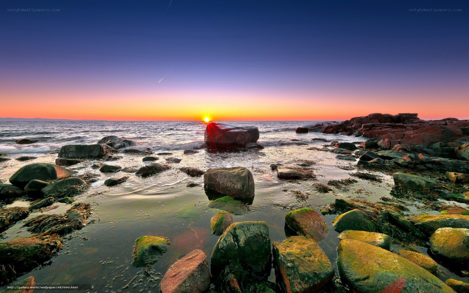 Sunset over rocky shoreline