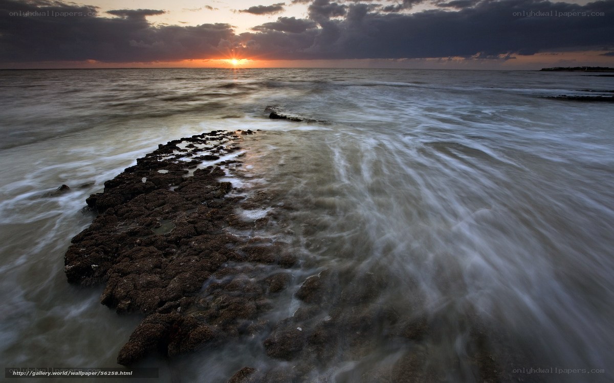 Sunset over rocky shoreline